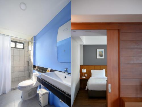 a blue bathroom with a sink and a bed at Estia Chiangmai in Chiang Mai