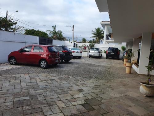 a group of cars parked in a parking lot at Royal-inn SPA & Pousada in Itanhaém