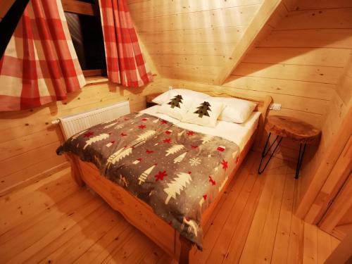 a bedroom with a bed in a cabin at Heidi in Zakopane