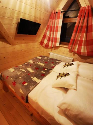 a bedroom with a bed in a cabin at Heidi in Zakopane