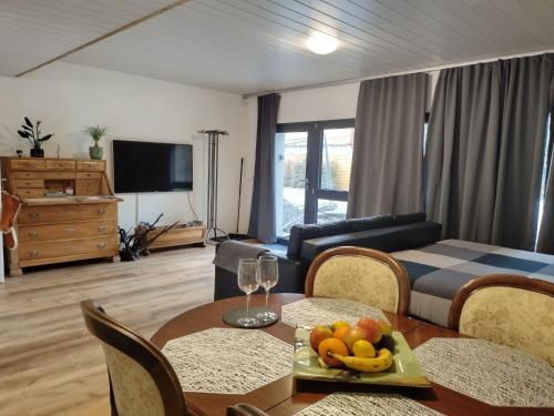 a living room with a table with fruit on it at Spacieux studio 38m2 in Les Paccots