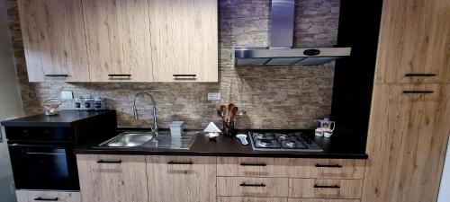 a kitchen with a sink and a stove top oven at TSUKI House in Marino