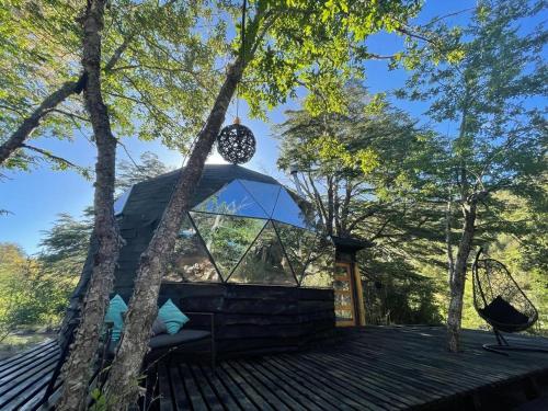 a house on top of a roof with trees at Black Domes in Nevados de Chillan