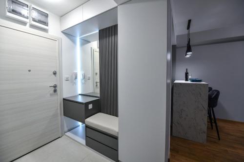 a bathroom with a bench next to a door at St'Petar apartment in Skopje