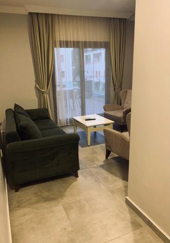 a living room with a couch and a table at Orya Aparts in Gümbet