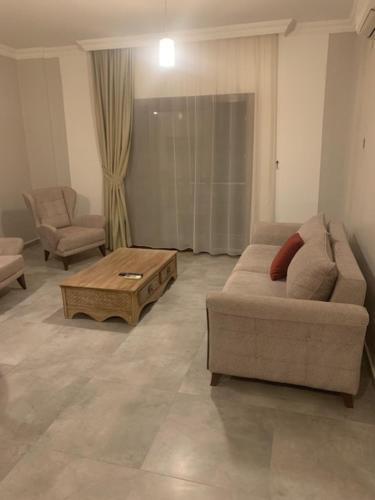 a living room with a couch and a coffee table at Orya Aparts in Gümbet