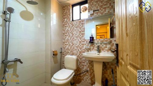 a bathroom with a toilet and a sink at Sunnyvale Defense Executive Apartments 913 in Islamabad