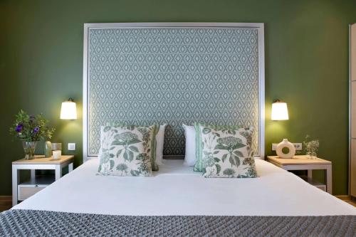a bedroom with a large white bed with pillows at Central Hotel, Trademark Collection by Wyndham in Bucharest