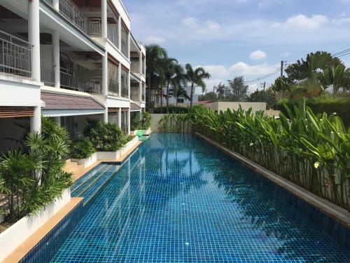 a swimming pool in front of a building at Bel Air Cape Panwa resort apartment in south Phuket with pool access ,near Ao Yon in Phuket