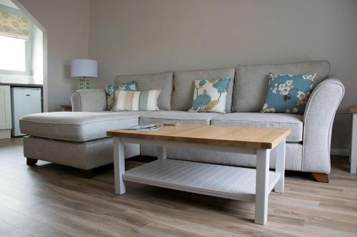 a living room with a couch and a coffee table at Rooftops in Louth