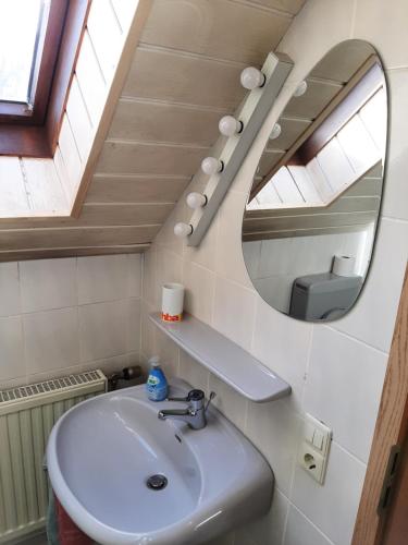 a bathroom with a sink and a mirror at Gästezimmer Löhrbacher Tal in Birkenau