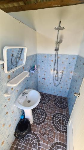 a bathroom with a sink and a shower at koh mook oyoy reggaebar bungalow in Koh Mook