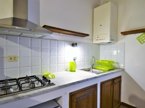 a kitchen with a sink and a stove top oven at Charming apartment in Mantignana with shared pool in Mantignana