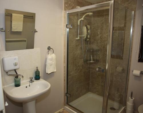 a bathroom with a shower and a sink at The Annexe in Thorpe