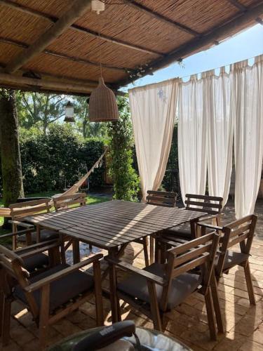 a wooden table and chairs on a patio at Le case di Anita in Toscana -Capalbio in Capalbio