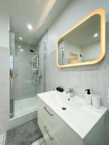 a white bathroom with a sink and a shower at Ferienwohnung Schönes Maifeld in Polch
