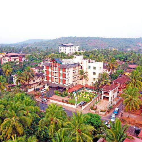 an aerial view of a city with palm trees and buildings at Godwin Goa in Candolim