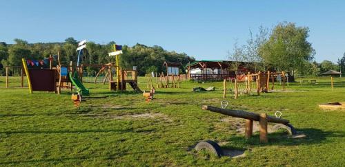 a park with a bunch of playground equipment in the grass at Dům nad jezerem - apartmán II. in Most