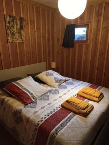 een slaapkamer met een bed met twee handdoeken erop bij La cabane du Truquet in Lège-Cap-Ferret