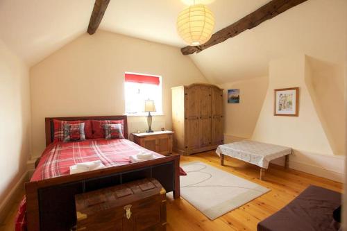 a bedroom with a large bed and a window at Dunnimere Farm stay with Hot Tub - up to 20 in Haselour