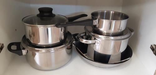 two pots and pans sitting on top of a stove at Hajas Família Kiadó Szobák in Balatonmáriafürdő