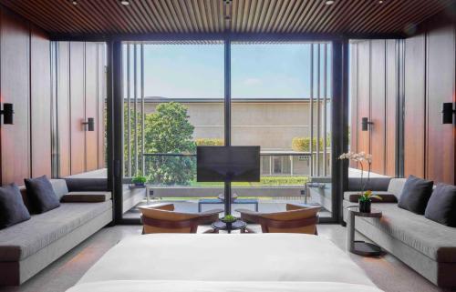 a large room with a bed and a large window at Lohkah Hotel & Spa-Free Welcome Fruit Plate in Xiamen