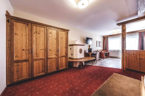 a large room with wooden cabinets and a desk at Hotel Rose in Mayrhofen