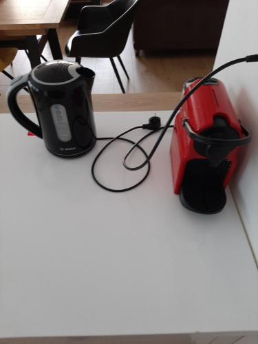 a coffee maker and a toaster sitting on a counter at Jolie suite parentale, chambre et salle d'eau, avec son coin de verdure à 5 minutes à pied du centre ville in Bordeaux