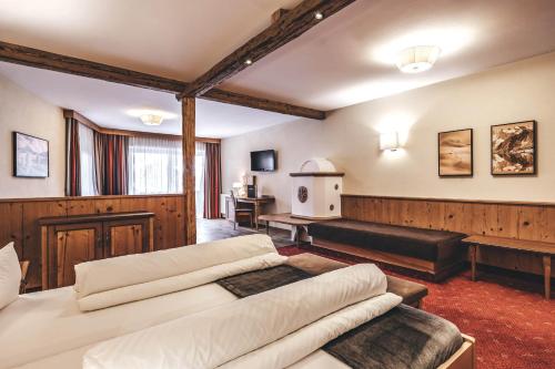 a living room with two beds and a couch at Hotel Rose in Mayrhofen