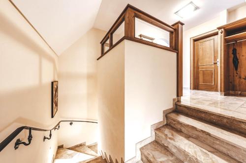 a staircase in a house with a wooden door at Hotel Rose in Mayrhofen