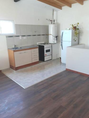 a kitchen with a refrigerator and a counter top at El mejor descanso II in Plottier