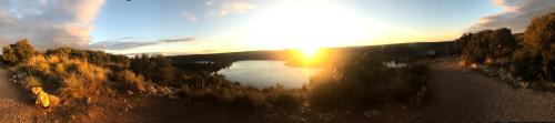 a view of a lake with the sun in the sky at Casas Rurales Lagunas de Ruidera II in Ossa de Montiel