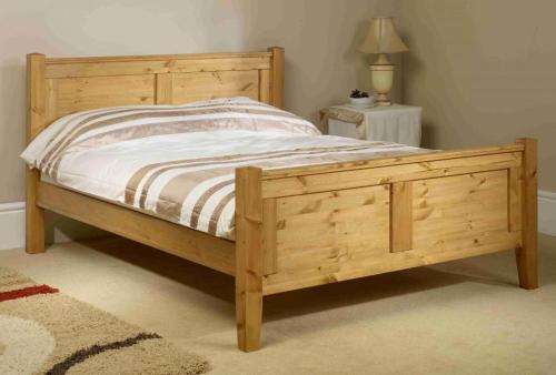 a wooden bed with a wooden frame in a bedroom at City Riverview Apartment with Parking in London