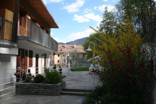 a courtyard of a house with a building at Hotel Krone in Brunico
