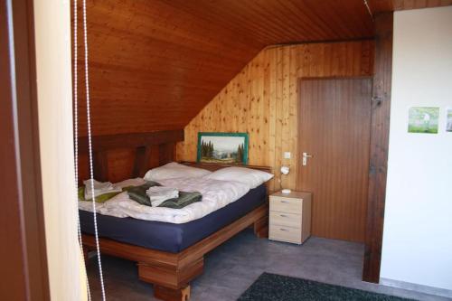 a swing bed in a room with wooden walls at Haus mit großem Garten 