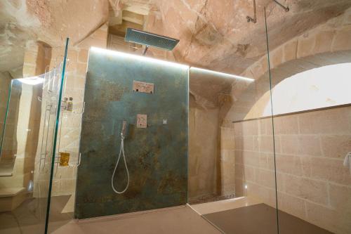 a bathroom with a shower with a glass door at La Casa di Ele in Matera