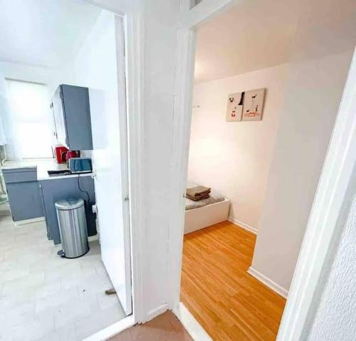 a white room with a kitchen and a hallway at Spacious Two Bedroom flat in Hither Green