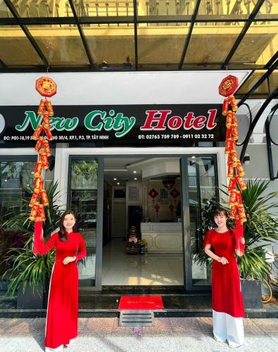 two women standing in front of a hotel at NEW CITY HOTEL in Tây Ninh