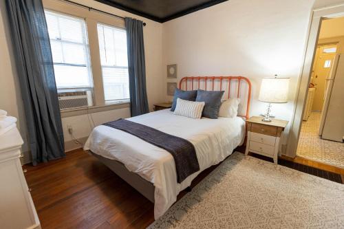 a bedroom with a large bed and a mirror at Historic Revival Midtown Memphis Duplex 64 Yes Pets Fast Wifi Free Parking in Memphis