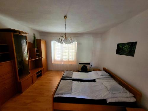 a bedroom with a large bed and a window at WatAir House Apartman Sarud in Sarud