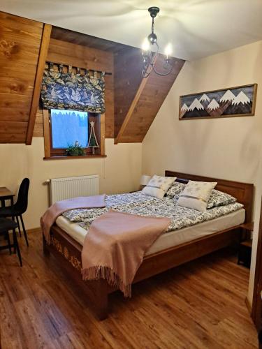 sypialnia z łóżkiem i stołem w obiekcie Willa Wschód Słońca w Bukowinie Tatrzańskiej