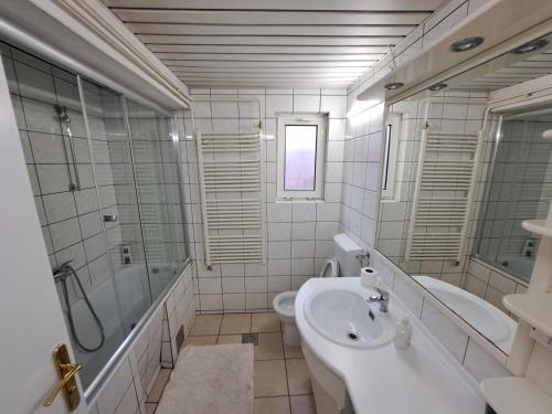 a bathroom with a sink and a tub and a toilet at Skopje Panorama in Skopje