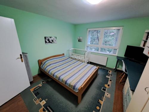 a small bedroom with a bed and a window at Skopje Panorama in Skopje