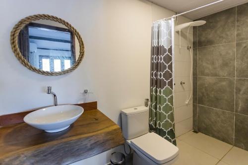 a bathroom with a sink and a shower at Flow Guest House in Salinópolis