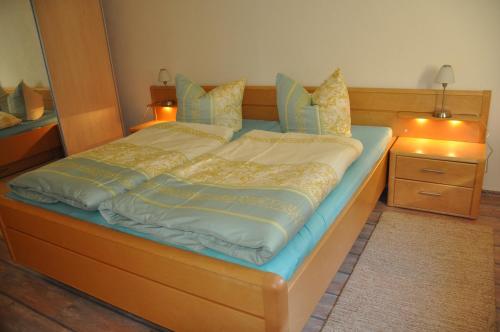a large bed in a bedroom with two night stands at Ferienwohnung an der Elbe in Stadt Wehlen
