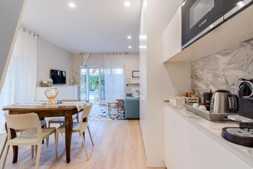 a kitchen and dining room with a table and chairs at Ariston & Casinò - Appartamento con Giardino e Garage in Sanremo