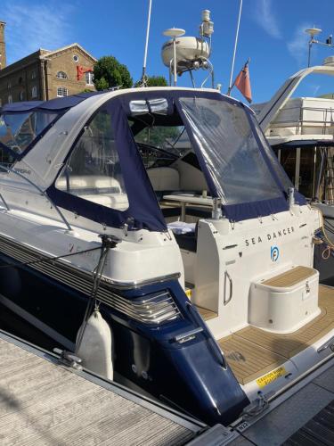 a boat with its door open on a dock at Entire Boat at St Katherine Docks 2 Available select using room options in London