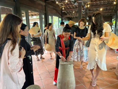 a group of women are standing around a vase at Champa Island Nha Trang - Resort Hotel & Spa in Nha Trang