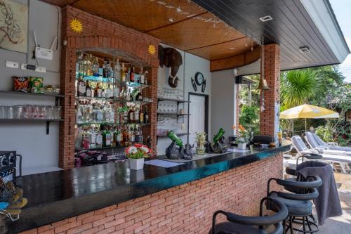 a bar in a restaurant with a brick wall at Harmony Naturist Resort Rawai Phuket 18yr minimum age only nudist nake d FKK in Rawai Beach