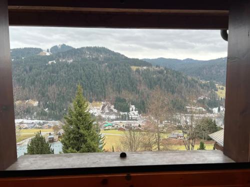 a window with a view of a mountain at Chalet Cosy Les Gets Vue Montagne in Les Gets